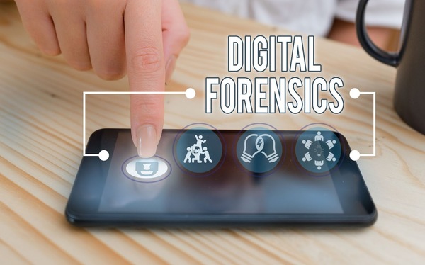 Finger pushing the screen of a tablet with the text Digital Forensics